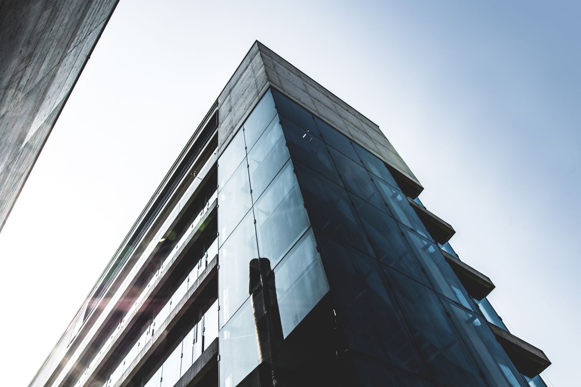 Glass high-rise building reflecting the sky, representative of Velion's commercial service portfolio